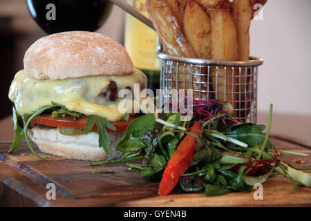 Homemade Cheese Burger, twice cooked chips and salad Stock Photo