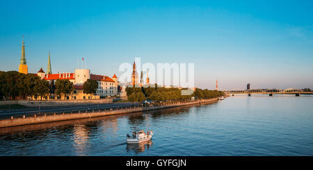 Scenic View To Promenad Of Daugava, In Riga, Latvia. Old Church Towers And Medieval Castle On Background. Seafront Named Ab Damb Stock Photo