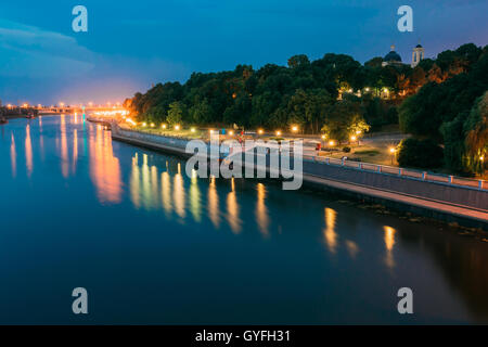 The Scenic Summer Evening View Of Sozh River, Illuminated Embankment And Ancient Greenwood Park, Cathedral Of St. Peter And Paul Stock Photo