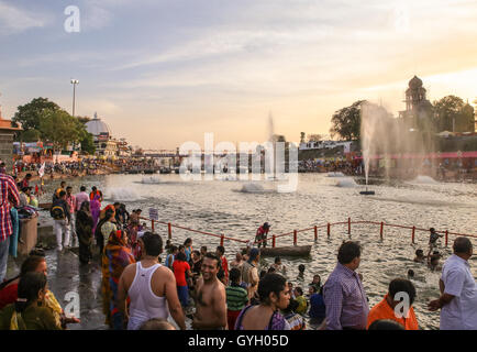 The Pujas (prayers) in India during the Khumb Mela  -  27/04/2016  -  India / Madhya Pradesh / Ujjain  -  During the Khumb Mela, millions of pilgrims attend the great pujas every night on the banks of the river Shipra. The puja is a hindu ritual of offering and adoration. The ceremony starts with a bell tinkling to call the deities and follows with the offering of fresh flowers, incense, spices and candies going with music and mantras. The puja has a predominant role during the Khumb Mela combined with the holy baths in the river, which at this time are charged with healing powers due to the m Stock Photo