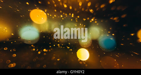 Glowing Lights On Unfocused Bokeh Blurred Dark Background. Stock Photo