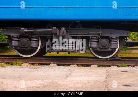 Train Wheels on Railroad. Detail of  Rustic Blue Wagon Stock Photo