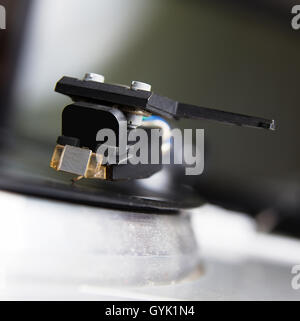 Turntable playing vinyl record with music. Useful equipment for DJ, nightclub and retro hipster theme or audio enthusiast. Stock Photo