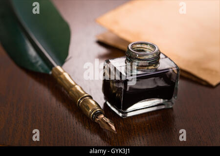 Quill pen, inkwell and paper Stock Photo