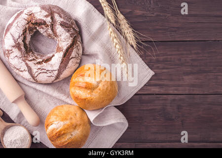 Rye bread and buns on table rustic style Stock Photo