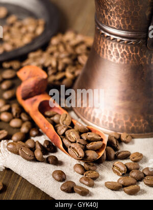 Showel with coffee beans and turkish coffee brewing pot Stock Photo