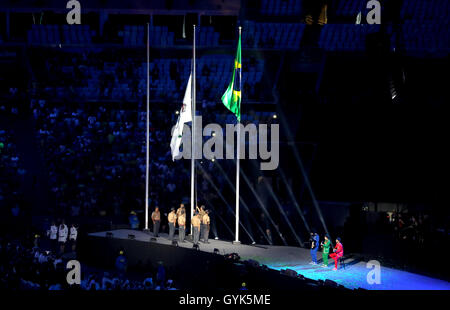 The Paralympic Anthem is played by Daniel Santiago (acoustic guitar), Pedro Martins (electric guitar) and Mestrinho (accordion) as the Paralympic flag is lowered by soldiers during the closing ceremony on the eleventh day of the 2016 Rio Paralympic Games at the Maracana, Rio de Janeiro, Brazil. Stock Photo