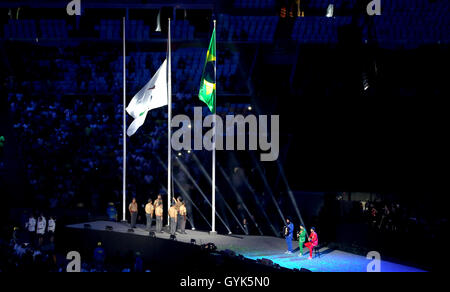 The Paralympic Anthem is played by Daniel Santiago (acoustic guitar), Pedro Martins (electric guitar) and Mestrinho (accordion) as the Paralympic flag is lowered by soldiers during the closing ceremony on the eleventh day of the 2016 Rio Paralympic Games at the Maracana, Rio de Janeiro, Brazil. Stock Photo