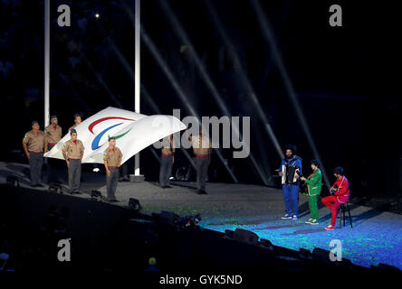 The Paralympic Anthem is played by Daniel Santiago (acoustic guitar), Pedro Martins (electric guitar) and Mestrinho (accordion) as the Paralympic flag is lowered by soldiers during the closing ceremony on the eleventh day of the 2016 Rio Paralympic Games at the Maracana, Rio de Janeiro, Brazil. Stock Photo