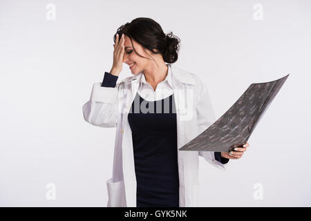 Beautiful female doctor nurse holding x-ray tired Stock Photo