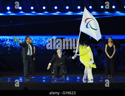 The Mayor of Rio de Janeiro Eduardo Paes (left) applauds as President of the IPC Sir Philip Craven (centre) hands the Paralympic flag to the Governor of Tokyo Yuriko Koike during the closing ceremony on the eleventh day of the 2016 Rio Paralympic Games at the Maracana, Rio de Janeiro, Brazil. PRESS ASSOCIATION Photo. Picture date: Sunday September 18, 2016. Photo credit should read: Adam Davy/PA Wire. EDITORIAL USE ONLY Stock Photo