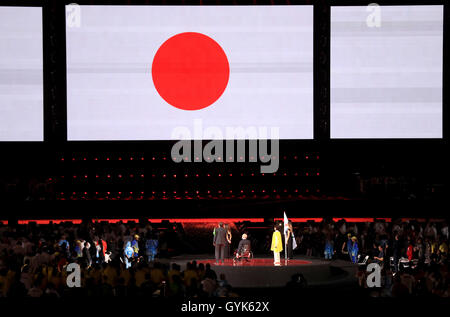 The Mayor of Rio de Janeiro Eduardo Paes (left) President of the IPC Sir Philip Craven (centre) and the Governor of Tokyo Yuriko Koike look on as the Japanese flag is displayed on the big screen during the closing ceremony on the eleventh day of the 2016 Rio Paralympic Games at the Maracana, Rio de Janeiro, Brazil. Stock Photo