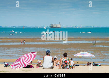 Cockle pickers on the beach, Fort Boyard at La Boyardville on ile d'oleron, France Stock Photo