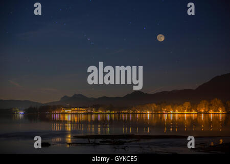illuminated house reflecting in the lake Chiemsee, Germany, Bavaria, Lake Chiemsee Stock Photo