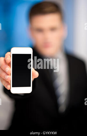 Salesman displaying newly launched mobile Stock Photo