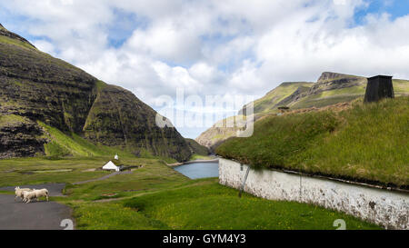 The church and a historic building in Saksun, Streymoy island. Faroe Islands Stock Photo