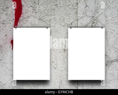Close-up of two blank frames hanged by clothes hangers against rough gray wood background Stock Photo