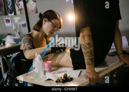 A tattoo fan has net stockings tattooed on his legs at the 19th  International Tattoo Convention in Frankfurt Main, Germany, 16 April 2011.  More than 700 tattoers from around 20 countries display