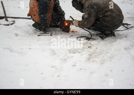 December 17, 2009 - Welders working on snow during a snowfall © Igor Goiovniov/ZUMA Wire/17�Թ����� Live News Stock Photo