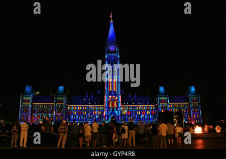 People watching Northern Lights, an illuminated light show sponsored by Government of Canada and Manulife on Parliament Hill, Ot Stock Photo