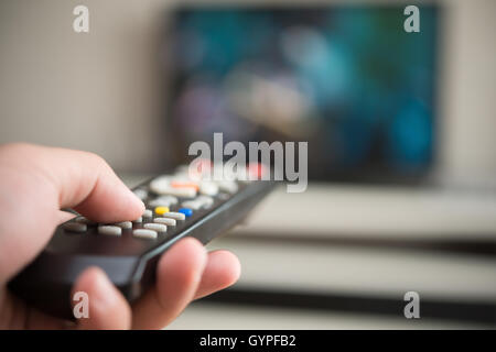 man operating a TV remote control Stock Photo