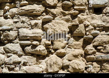 detail of the old wall of the ruined stones and without plaster Stock Photo