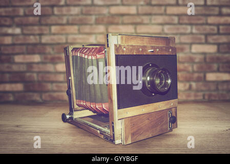 Antique Old photo Camera on wooden table Stock Photo