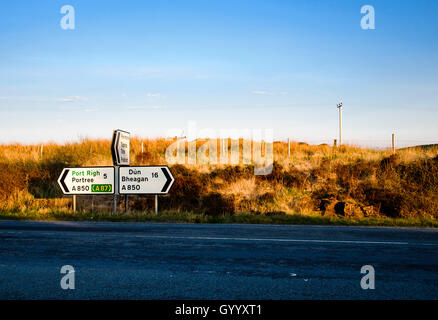 Signpost on a road in the evening light, Skeabost, Isle of Skye, Highland, Scotland, United Kingdom