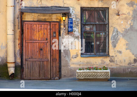 Grungy front door of residential house in Russia Stock Photo