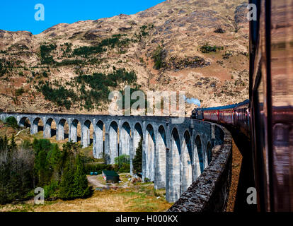 Vintage train 'The Jacobite' Steam Train driving over the Glenfinnan Viaduct, Glenfinnan, Highland, Scotland, United Kingdom Stock Photo