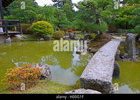 typical Japanese garden with stone decoration and koi pond Stock Photo