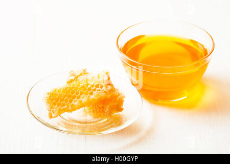 Honey and honeycomb on a white table Stock Photo