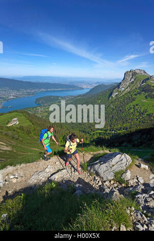 two hiker on a path to mount La Tournette, Lake Annecy in background, France, Savoie, Haute Savoie, Annecy Stock Photo