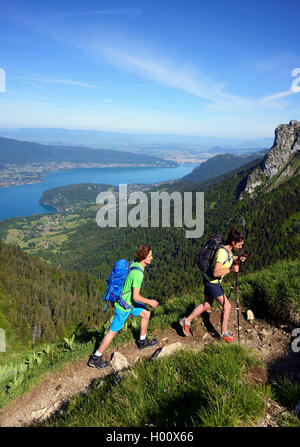 two hiker on a path to mount La Tournette, Lake Annecy in background, France, Savoie, Haute Savoie, Annecy Stock Photo