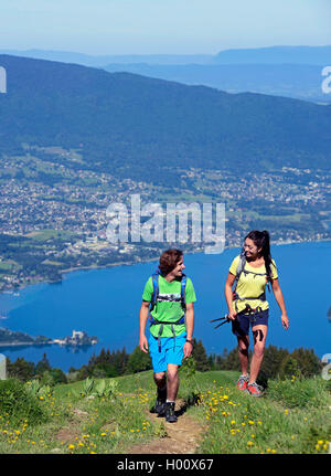 two hiker on a path to mount La Tournette, Lake Annecy in background, France, Savoie, Haute Savoie, Annecy Stock Photo