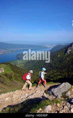 two hiker on a path to mount La Tournette, Lake Annecy in background, France, Savoie, Haute Savoie, Annecy Stock Photo