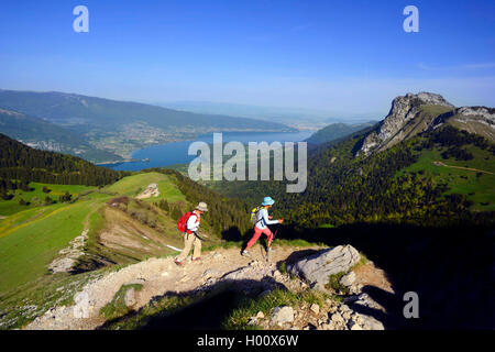 two hiker on a path to mount La Tournette, Lake Annecy in background, France, Savoie, Haute Savoie, Annecy Stock Photo