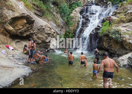 RAVANA FALLS, SRI LANKA - MARCH 2, 2014: Local tourists at Ravana falls, popular sightseeing attraction and one of the widest fa Stock Photo