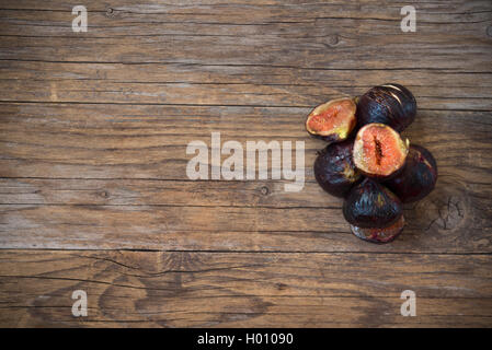 black natural figs sliced  on wooden table Stock Photo