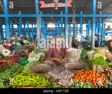 HIKKADUWA, SRI LANKA - FEBRUARY 23, 2014: Local street vendor selling spices. The Sunday market is great way to see Hikkaduwa's  Stock Photo