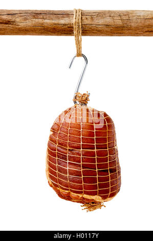 Smoked boneless pork ham hock wrapped in netting hanging on a hook from a wooden pole isolated on white Stock Photo