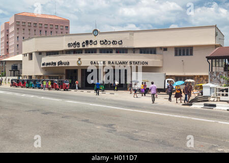 GALLE, SRI LANKA - MARCH 9, 2014: People in front of Galle railway station. The station is part of the Coast Line, which links S Stock Photo