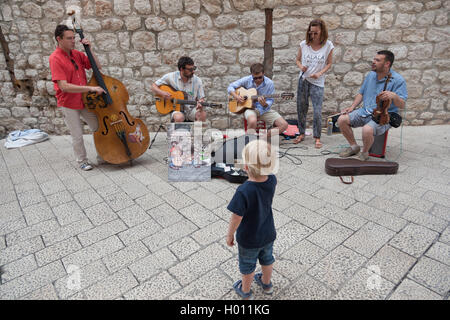DUBROVNIK, CROATIA - MAY 27, 2014: Street musicians performing in the srteets of the old town of Dubrovnik, Croatia. Stock Photo