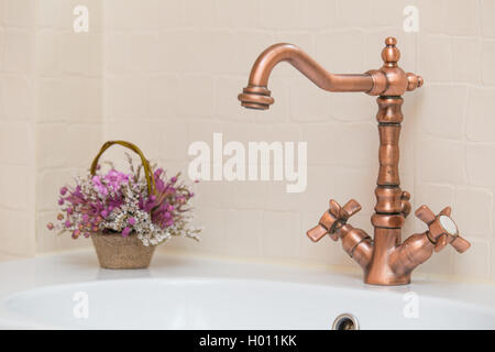 Bronze tap in bathroom Stock Photo