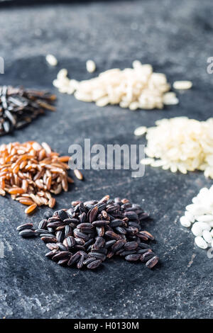 Different rice varieties on old table. Stock Photo