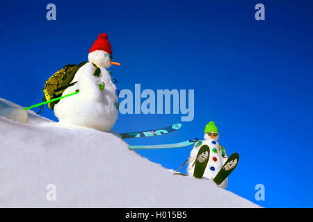 two snowmen in skiing clothing, France, Savoie Stock Photo