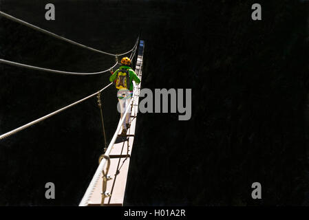 climber on simple suspension bridge, Via Ferrata du Grand Vallon ValfrÚjus, France, Savoie Stock Photo