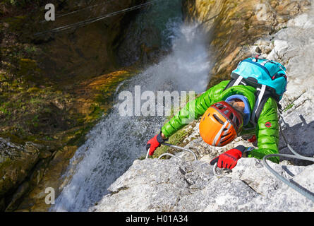 climber at waterfall of the Nants, Via Ferrata de Bellevaux, France, Haute-Savoie Stock Photo