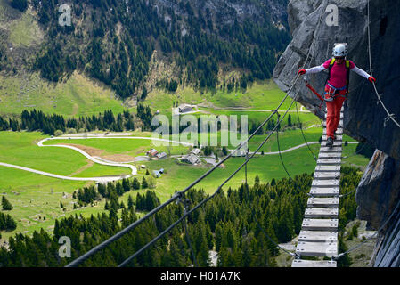 climber on simple suspension bridge, Via ferrata Yves Pollet-Villard, France, Haute Savoie, La Clusaz Stock Photo