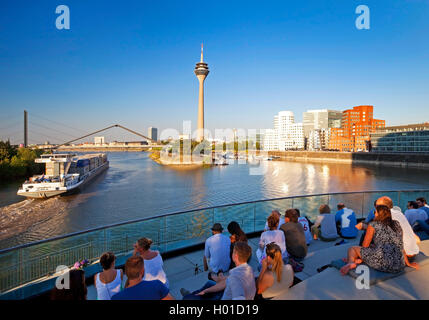 people on a restaurant terrace with view onto the Rhine tower, Germany, North Rhine-Westphalia, Duesseldorf Stock Photo